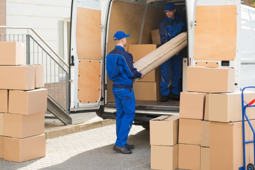 Removal team planning a safe move with insured van services in Acton