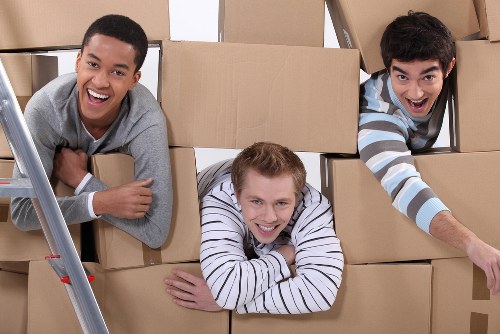 Careful packing of household items for a move in Acton