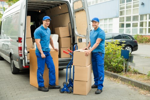 Acton flat move with boxes and furniture being carried carefully