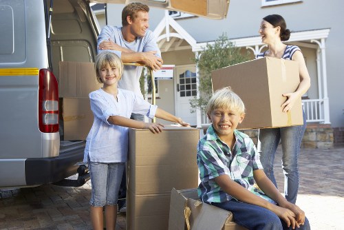 Specialist movers transporting a baby grand piano for a local Acton customer