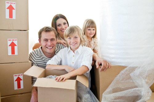 Loading boxes and furniture into a moving van in Acton