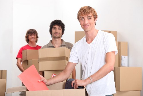 Professional movers organizing a removal van in Acton