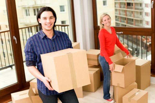 Loading household furniture into a van for an Acton relocation